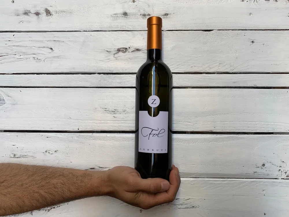 Bottiglia di vino di piccoli produttori su legno bianco